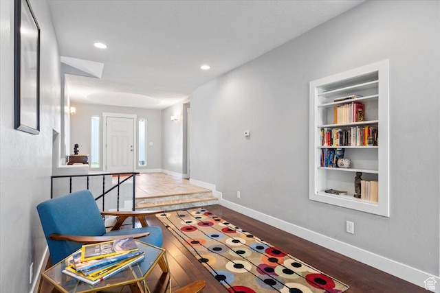 interior space with built in features, baseboards, recessed lighting, and wood finished floors