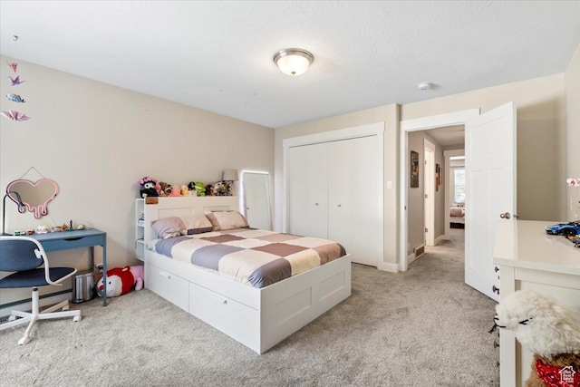 bedroom with a closet and light colored carpet