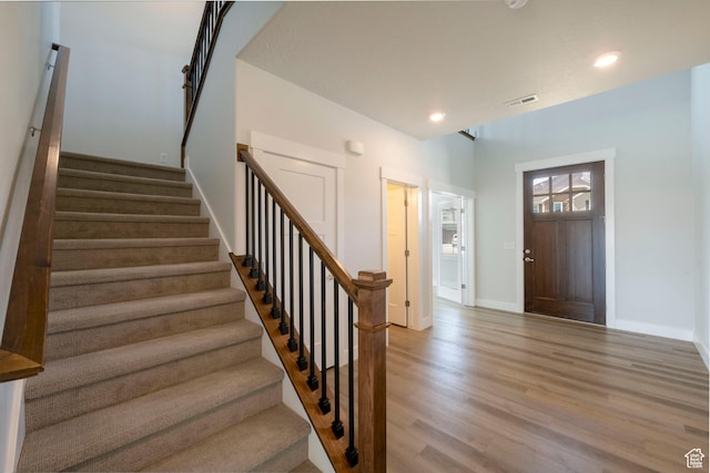 foyer with baseboards, recessed lighting, stairs, visible vents, and light wood finished floors