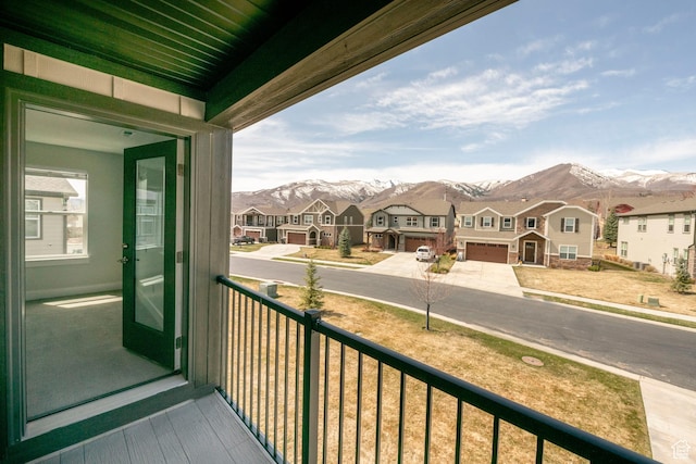 balcony featuring a residential view and a mountain view