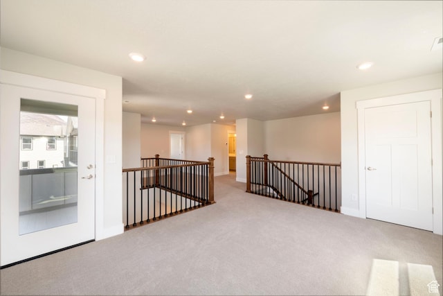 carpeted empty room with baseboards and recessed lighting