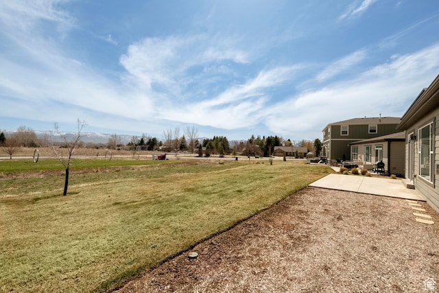 view of yard featuring a rural view and a patio