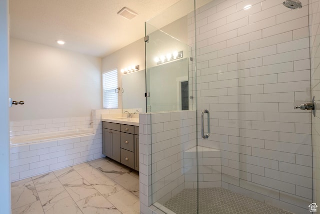 bathroom featuring a garden tub, a shower stall, vanity, recessed lighting, and marble finish floor