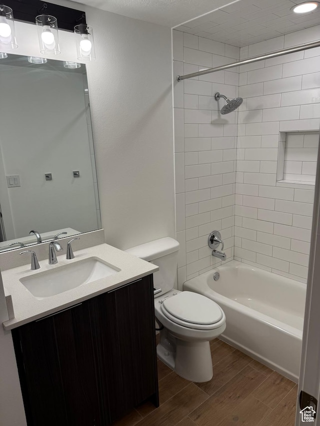 3049 S Orchard Dr Unit B, Bountiful, UT 84010 - full bathroom with toilet, shower / washtub combination, wood finished floors, and vanity