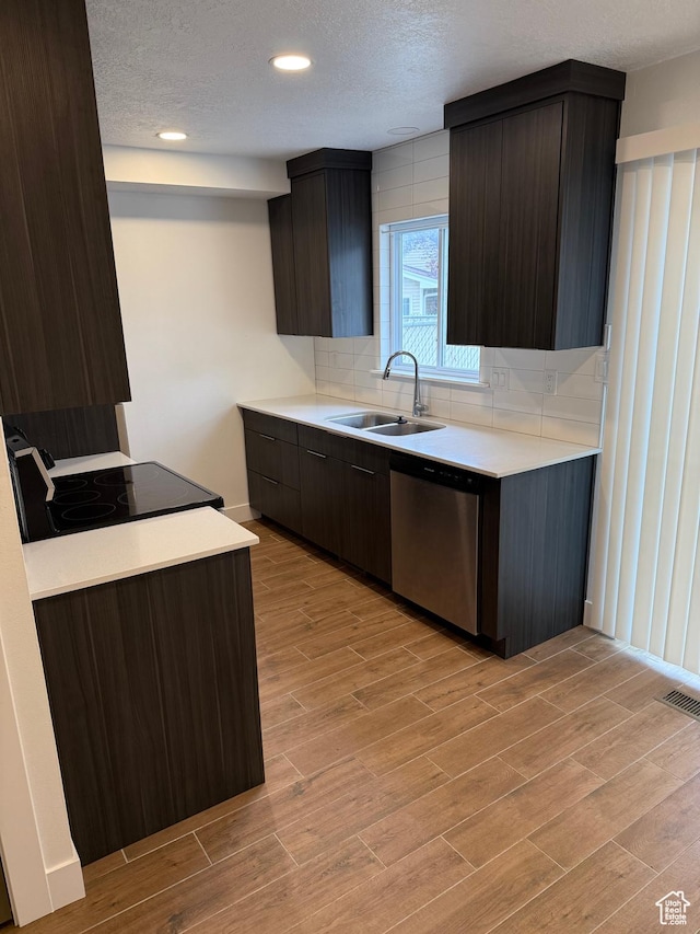 3049 S Orchard Dr Unit B, Bountiful, UT 84010 - kitchen featuring light wood-style flooring, dishwasher, a sink, light countertops, and backsplash