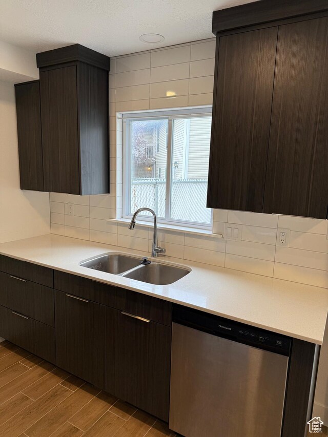 3049 S Orchard Dr Unit B, Bountiful, UT 84010 - kitchen with a sink, light countertops, dark brown cabinets, stainless steel dishwasher, and decorative backsplash