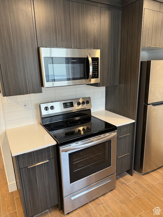 3049 S Orchard Dr Unit B, Bountiful, UT 84010 - kitchen with modern cabinets, light countertops, decorative backsplash, and stainless steel appliances