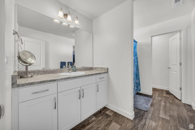14843 S Beckenbauer Ave, Herriman, UT 84096 - bathroom featuring vanity, baseboards, visible vents, and wood finished floors