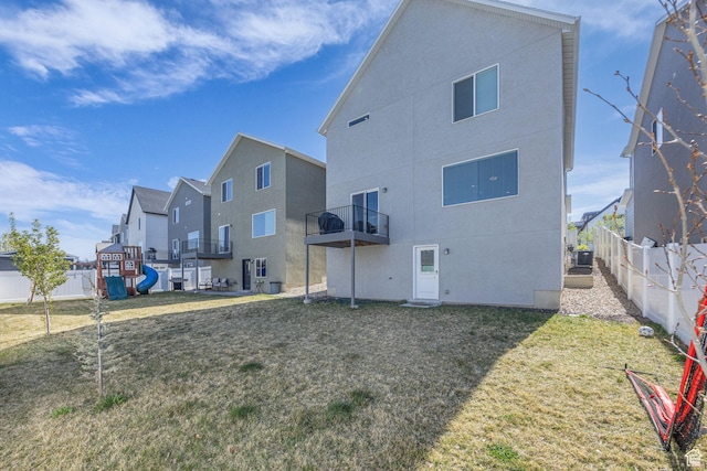 14843 S Beckenbauer Ave, Herriman, UT 84096 - back of house featuring central AC, a lawn, fence, stucco siding, and a residential view