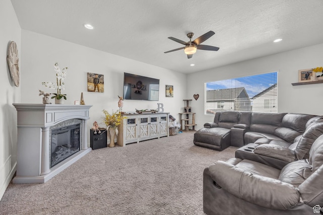 14843 S Beckenbauer Ave, Herriman, UT 84096 - carpeted living room featuring a textured ceiling, a ceiling fan, a glass covered fireplace, and recessed lighting