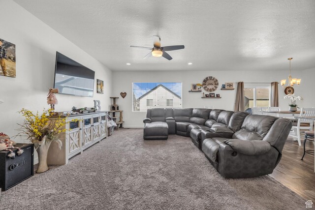 14843 S Beckenbauer Ave, Herriman, UT 84096 - carpeted living area with a textured ceiling and ceiling fan with notable chandelier