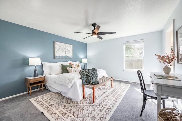 carpeted bedroom with baseboards, a ceiling fan, and a textured ceiling