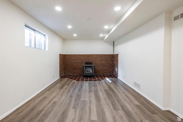 basement with recessed lighting, visible vents, baseboards, and wood finished floors