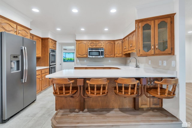 1769 Cobblestone Dr, Provo, UT 84604 - kitchen featuring stainless steel appliances, a peninsula, light countertops, glass insert cabinets, and brown cabinets