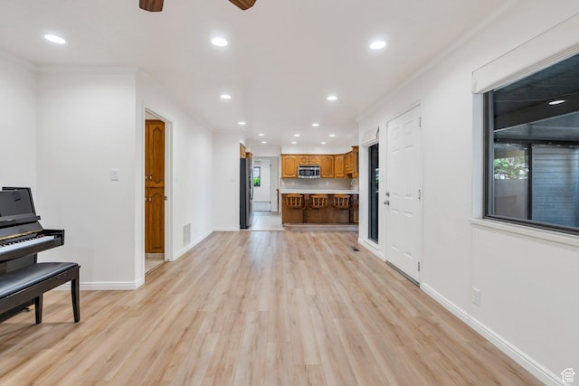 1769 Cobblestone Dr, Provo, UT 84604 - unfurnished living room with light wood finished floors, recessed lighting, ornamental molding, and a ceiling fan