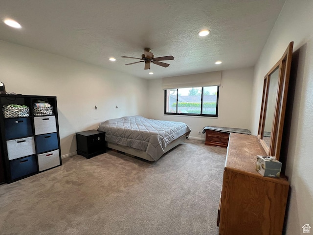 bedroom with carpet, baseboards, recessed lighting, and a textured ceiling