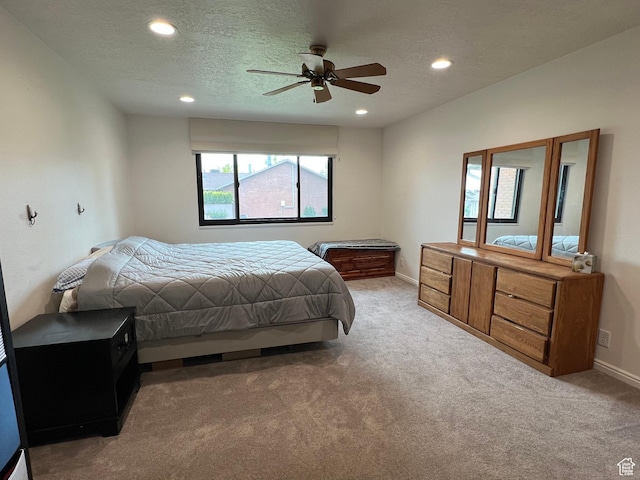 carpeted bedroom with baseboards, a textured ceiling, and recessed lighting
