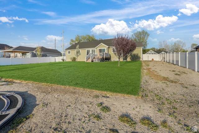 rear view of house with a fenced backyard, a residential view, and a lawn
