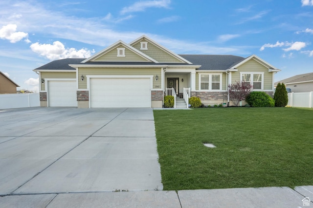 craftsman inspired home featuring driveway, stone siding, a front yard, a garage, and fence