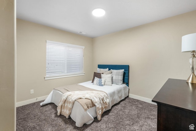 carpeted bedroom with visible vents and baseboards