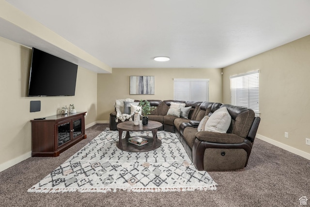 carpeted living area featuring baseboards