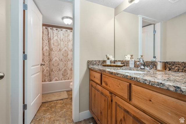 bathroom featuring shower / bath combo, visible vents, toilet, stone finish floor, and vanity
