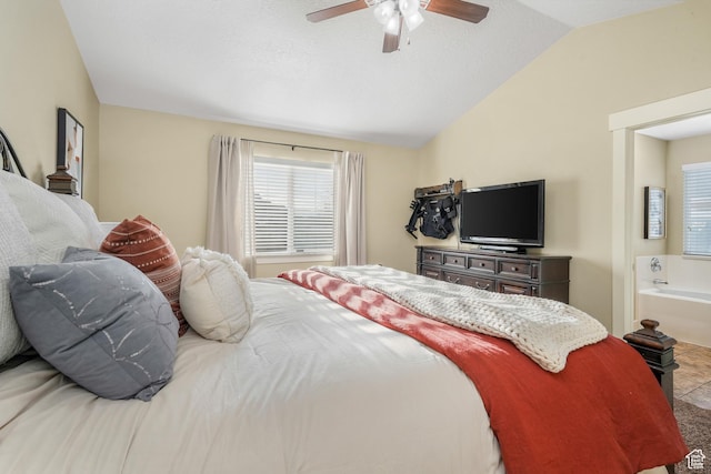 bedroom with ensuite bathroom, a ceiling fan, and vaulted ceiling