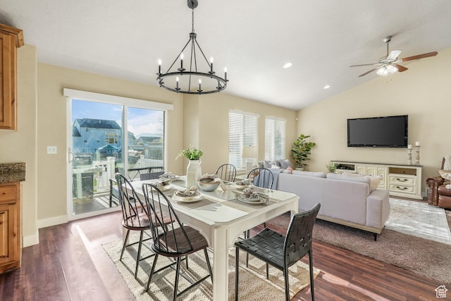 dining room with a healthy amount of sunlight, dark wood finished floors, and lofted ceiling