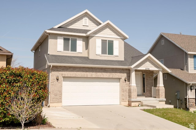 craftsman house with an attached garage, a shingled roof, driveway, and brick siding