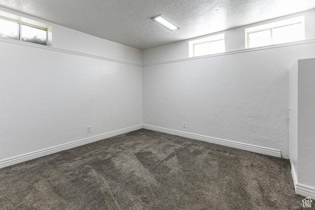 4455 S Aspen Hollow Ln, Holladay, UT 84117 - below grade area with baseboards, dark colored carpet, a textured wall, and a textured ceiling