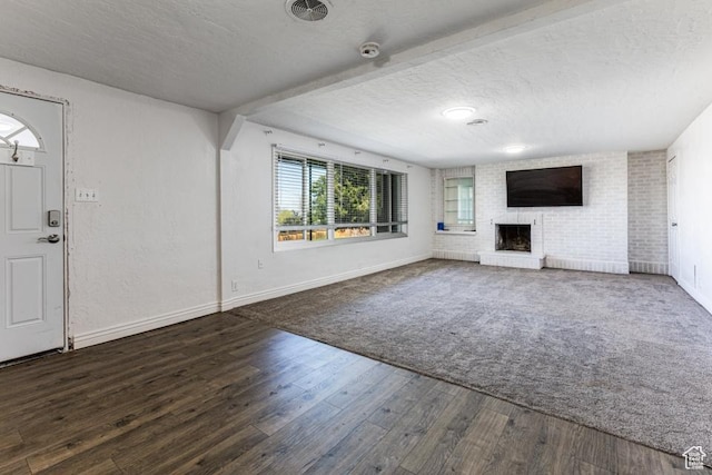 4455 S Aspen Hollow Ln, Holladay, UT 84117 - unfurnished living room with visible vents, a textured ceiling, baseboards, and a brick fireplace