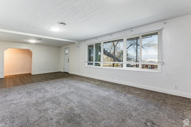 4455 S Aspen Hollow Ln, Holladay, UT 84117 - unfurnished living room featuring a wealth of natural light, a textured ceiling, baseboards, and carpet floors