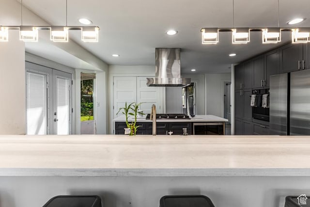 4455 S Aspen Hollow Ln, Holladay, UT 84117 - kitchen featuring recessed lighting, light countertops, island exhaust hood, and appliances with stainless steel finishes