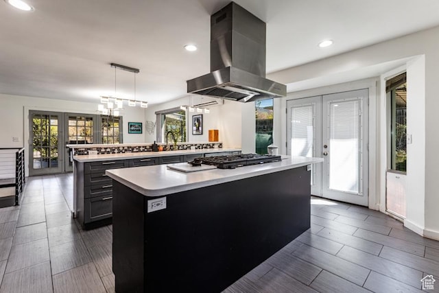 4455 S Aspen Hollow Ln, Holladay, UT 84117 - kitchen featuring french doors, island range hood, light countertops, and a kitchen island