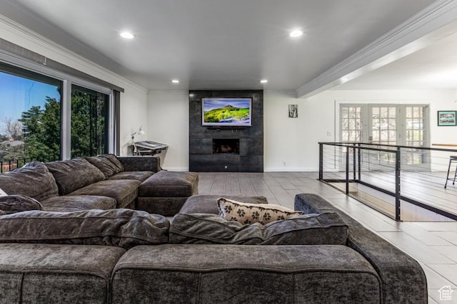 4455 S Aspen Hollow Ln, Holladay, UT 84117 - living area with a tiled fireplace, ornamental molding, baseboards, and recessed lighting