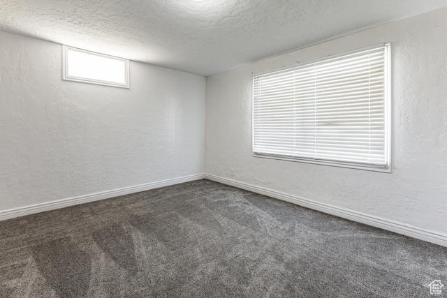 4455 S Aspen Hollow Ln, Holladay, UT 84117 - carpeted spare room with a textured ceiling, a textured wall, and baseboards
