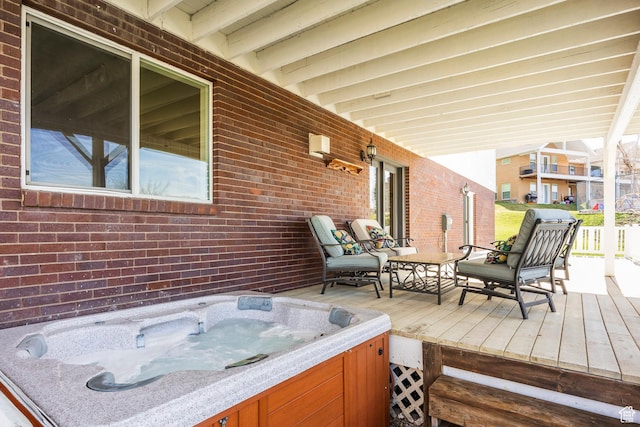 wooden terrace featuring a hot tub
