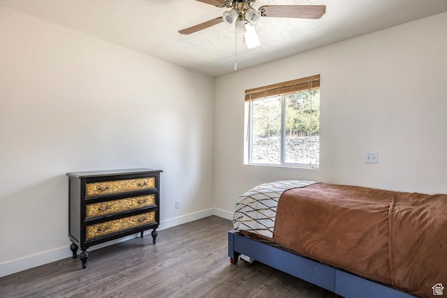 bedroom with baseboards, ceiling fan, and wood finished floors