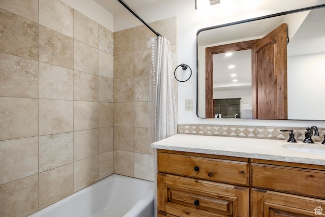 bathroom featuring shower / tub combo with curtain, vanity, and backsplash