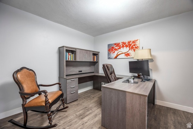home office with baseboards and wood finished floors