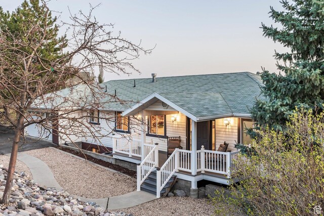 view of front of house featuring a porch and roof with shingles