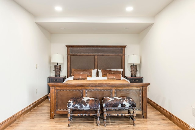 bedroom with light wood-style flooring and baseboards