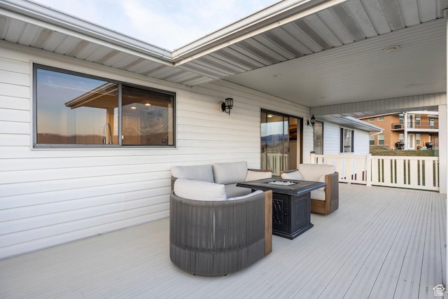 wooden deck with a fire pit