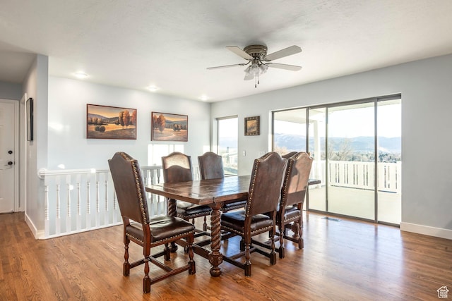 dining area featuring plenty of natural light, a ceiling fan, and wood finished floors