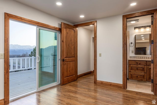 entryway with recessed lighting, baseboards, a mountain view, and wood finished floors