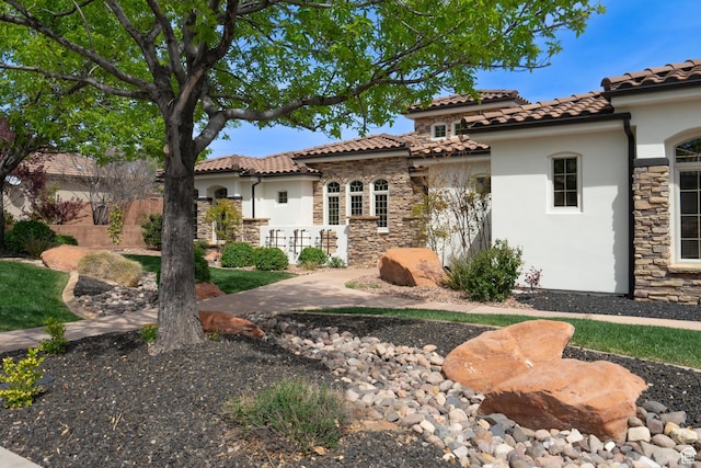 1844 N Wellington St, Washington, UT 84780 - rear view of house featuring stone siding, a tiled roof, and stucco siding