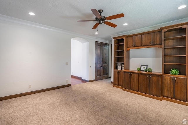 1844 N Wellington St, Washington, UT 84780 - unfurnished living room with crown molding, carpet flooring, arched walkways, a ceiling fan, and baseboards