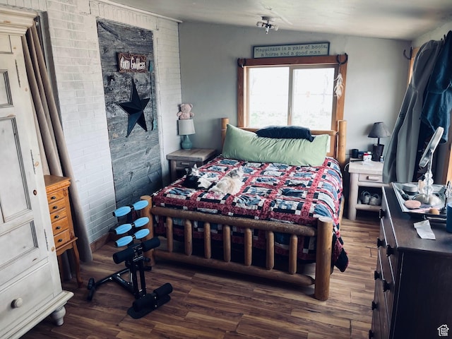4270 W 2000 N, Malad City, ID 83252 - bedroom featuring brick wall and dark wood-style flooring