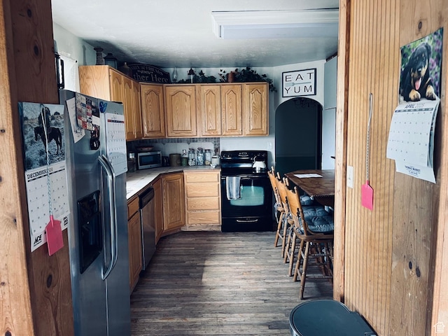 4270 W 2000 N, Malad City, ID 83252 - kitchen featuring dark wood-style flooring, light countertops, appliances with stainless steel finishes, and arched walkways