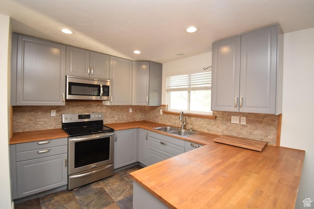 9111 S Parakeet Dr, Sandy, UT 84093 - kitchen featuring gray cabinetry, wood counters, a sink, and stainless steel appliances